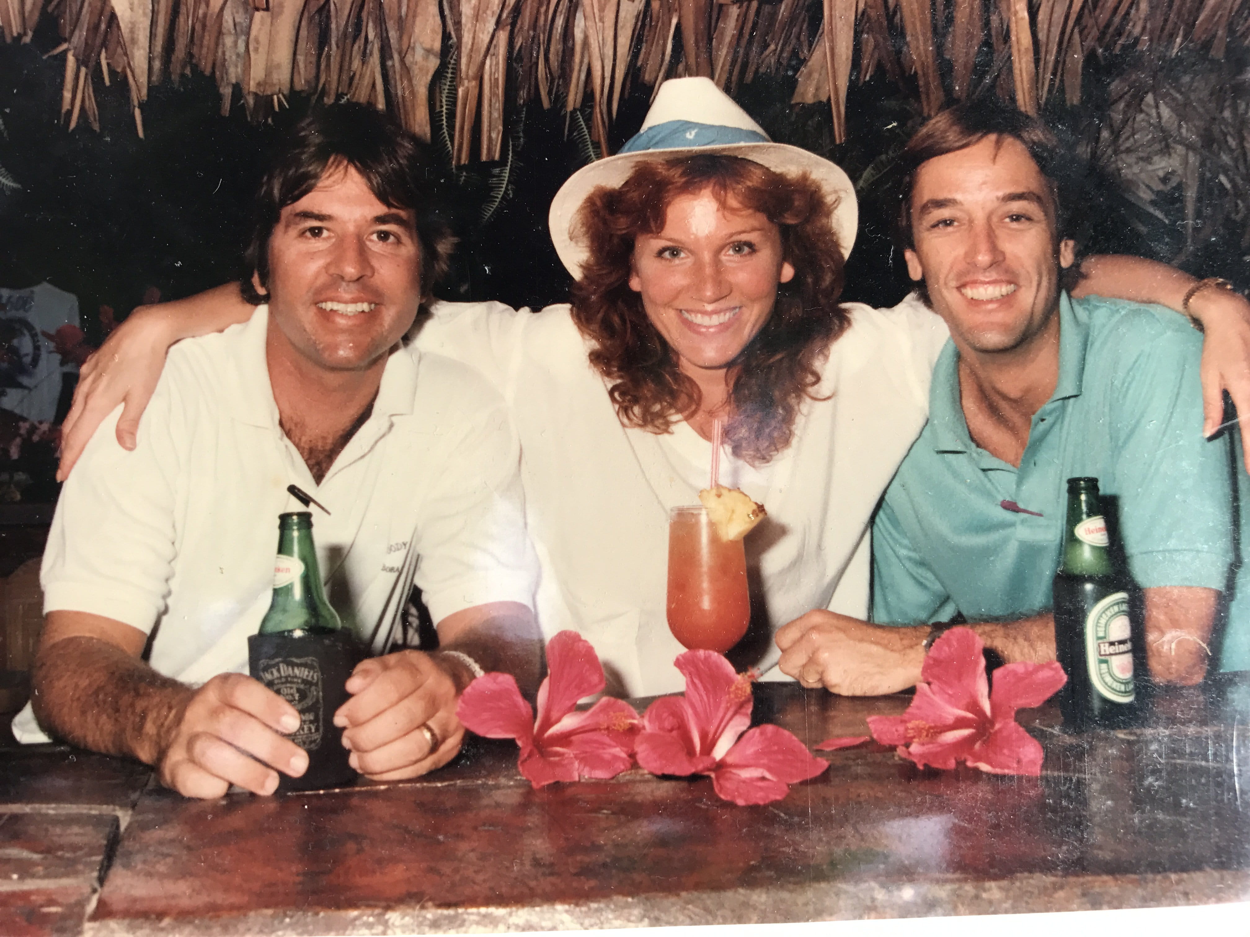 Actress Marilu Henner with Bloody Mary's staff beside heaped seafood iced displays under thatch lighting